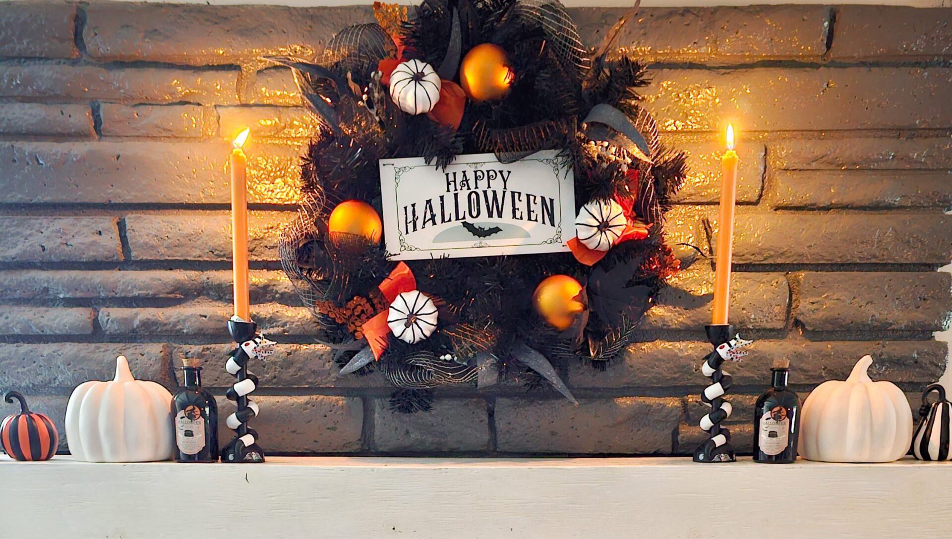 Spooky Fun Sales Store -Spooky Fun Sales Store Mantle Decorated with Wreath pumpkins and Beetlejuice candle stick holders
